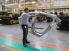 Gilbert Passin demonstrates how light the aluminum panels are...