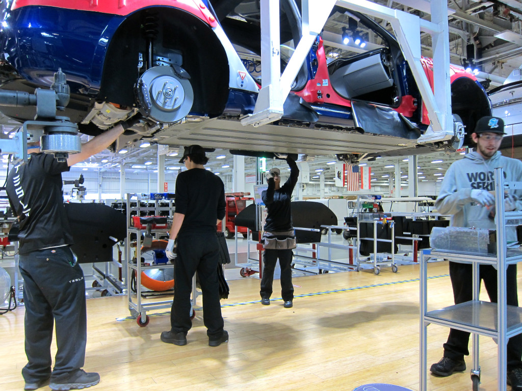 Men & Women on Tesla production line, photo by FreshDialogues