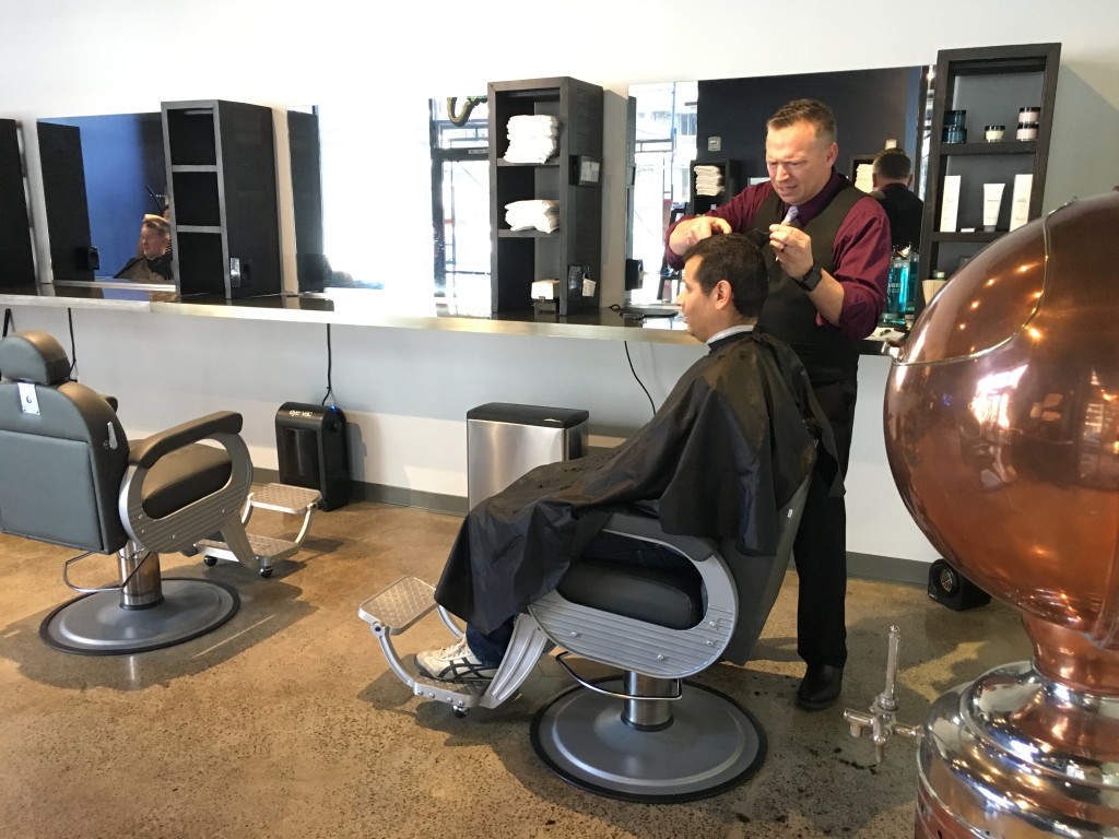 Dan Dixon cuts, listens at Crewners Barber shop in Silicon Valley, Photo by Alison van Diggelen
